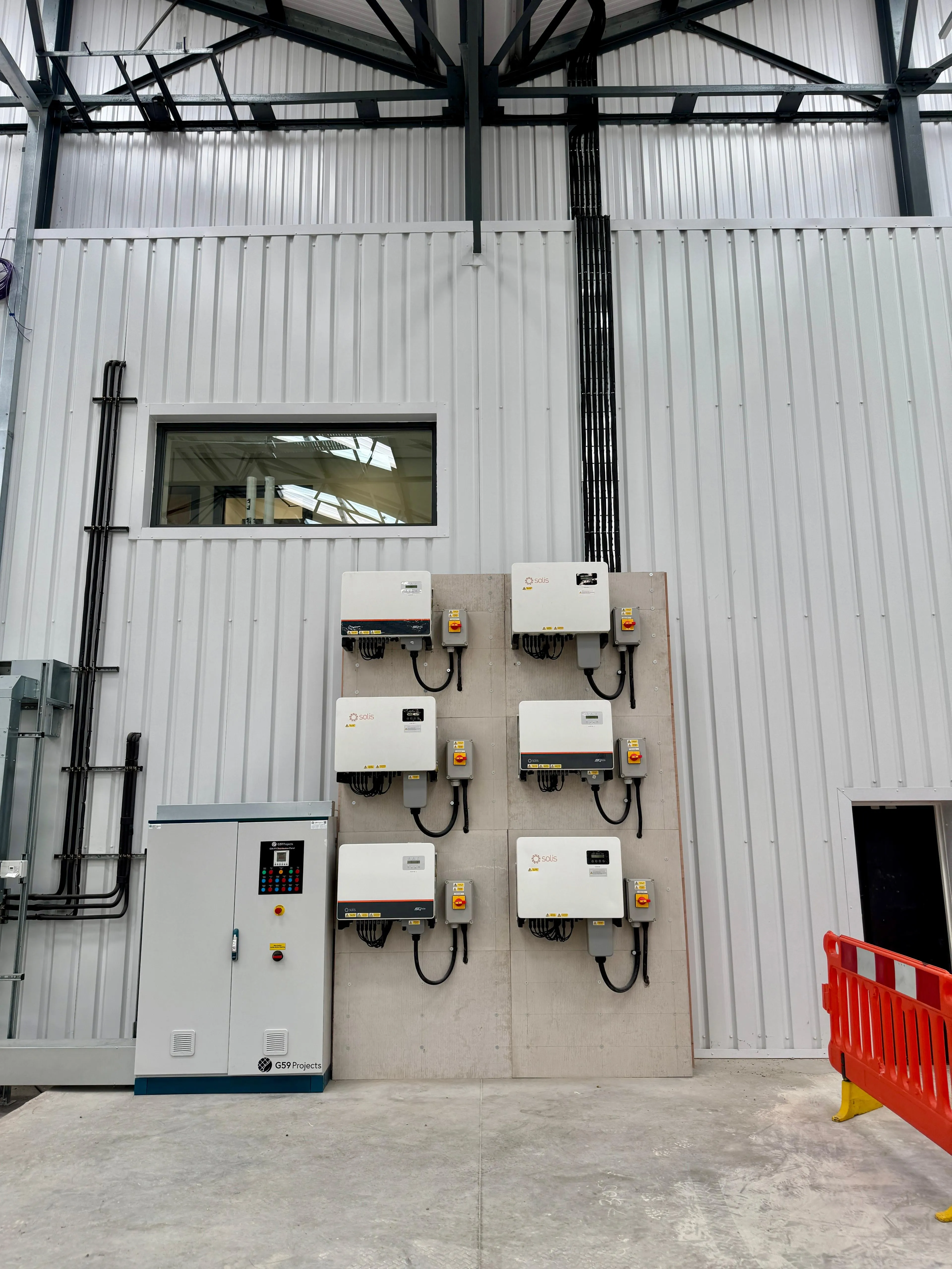 Wall of Solis inverters and commercial battery control equipment installed by Green Team Partnership