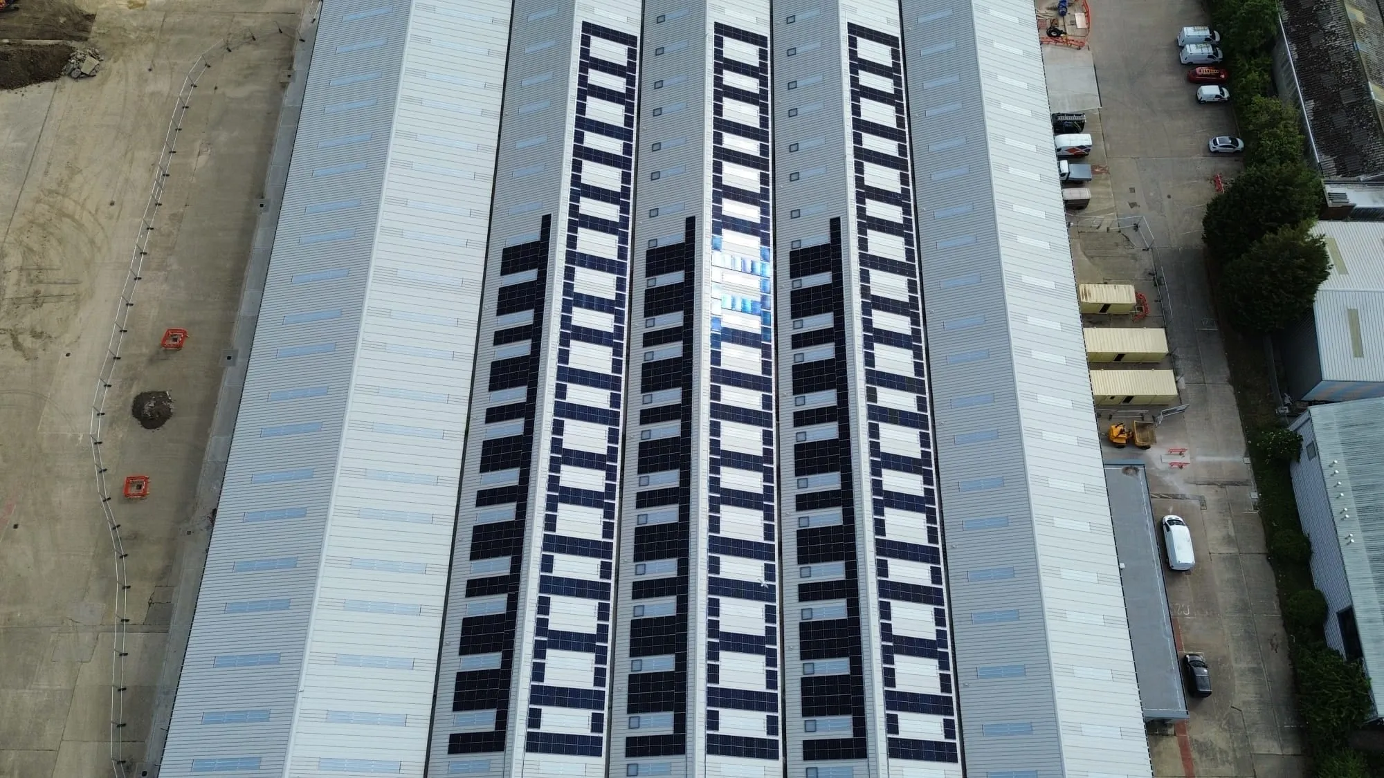 Overhead view of the panel rows running the length of the DHL warehouse roof