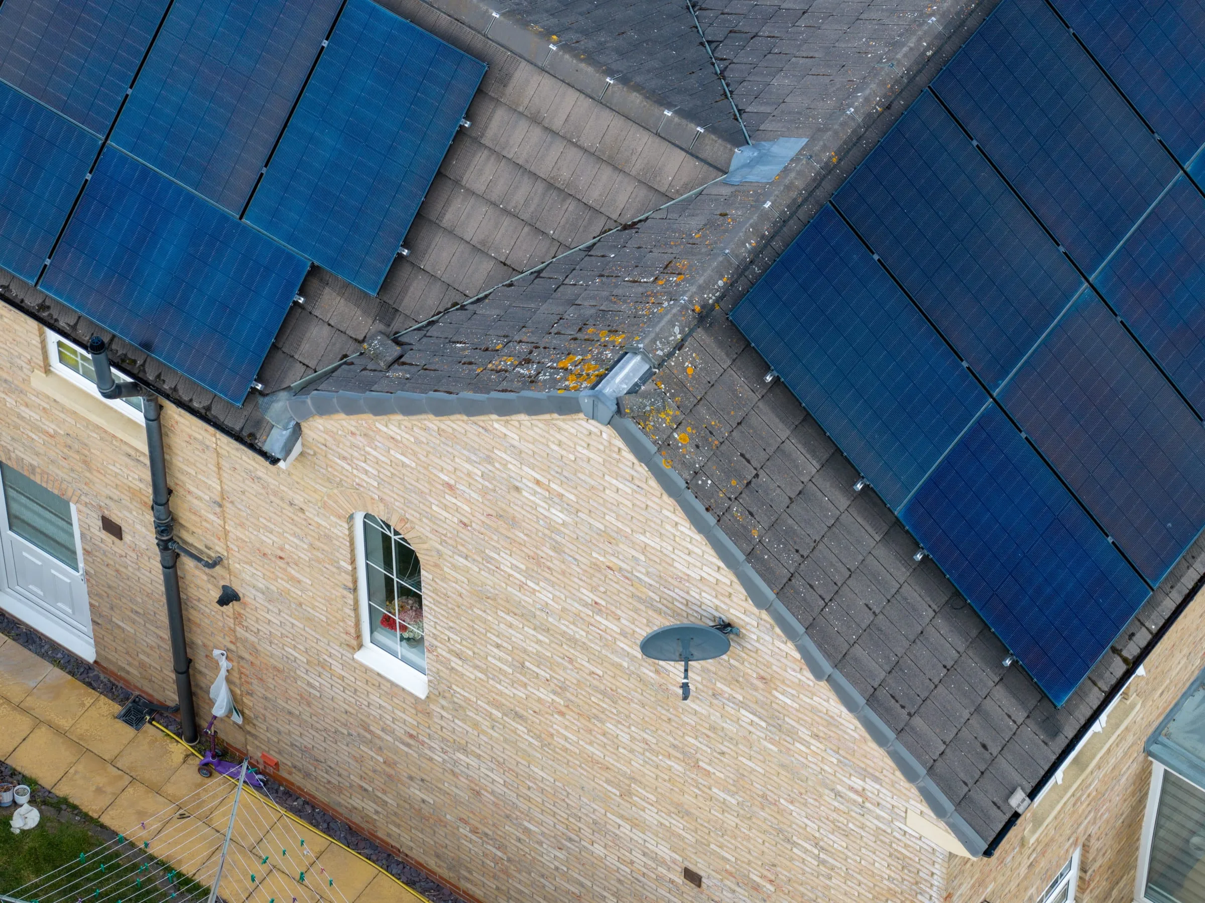 Aerial view of solar panels fitted across the roof of a UK family home