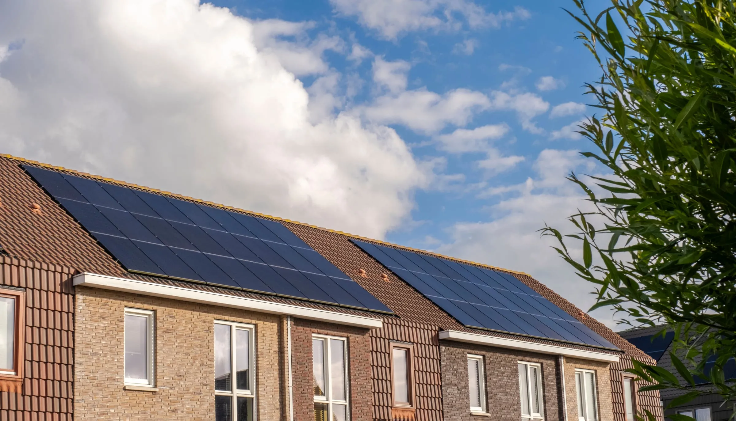 Row of terraced homes with solar panels fitted across their roofs