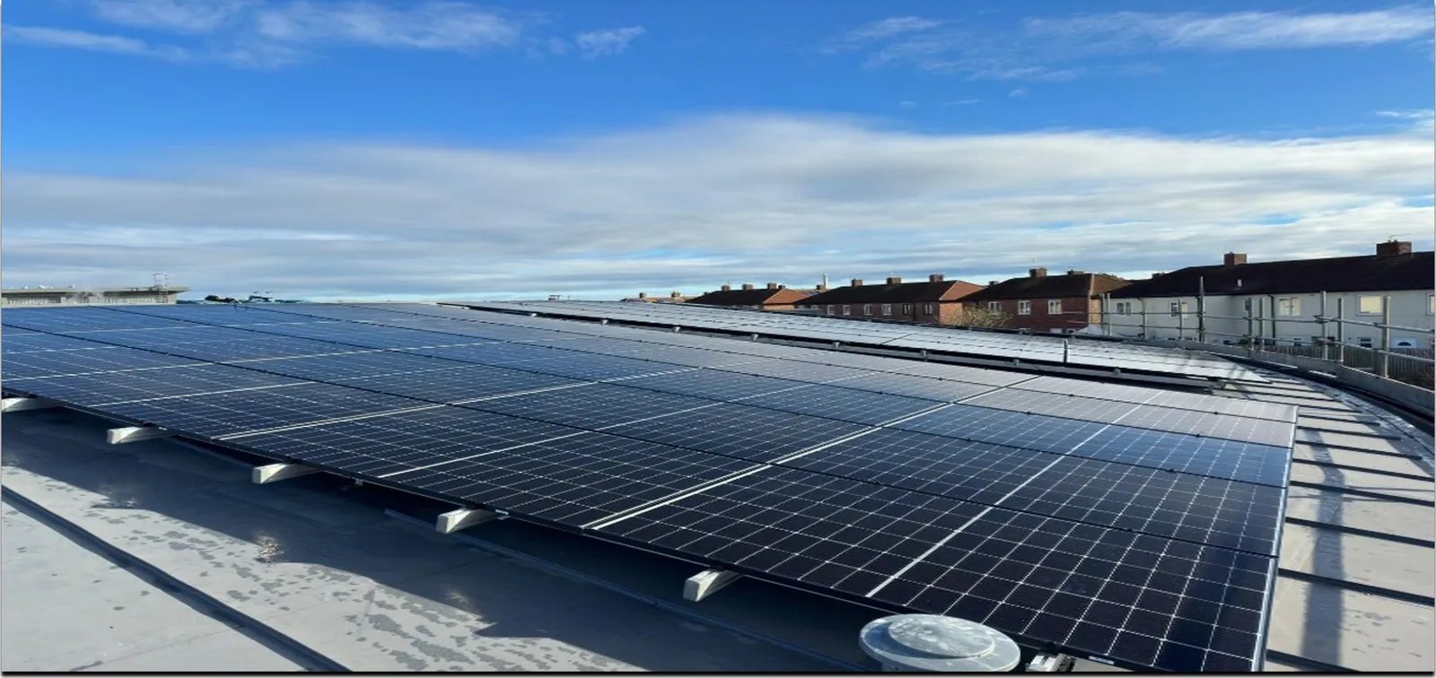 Solar panels across a South Tyneside Council school roof under blue sky
