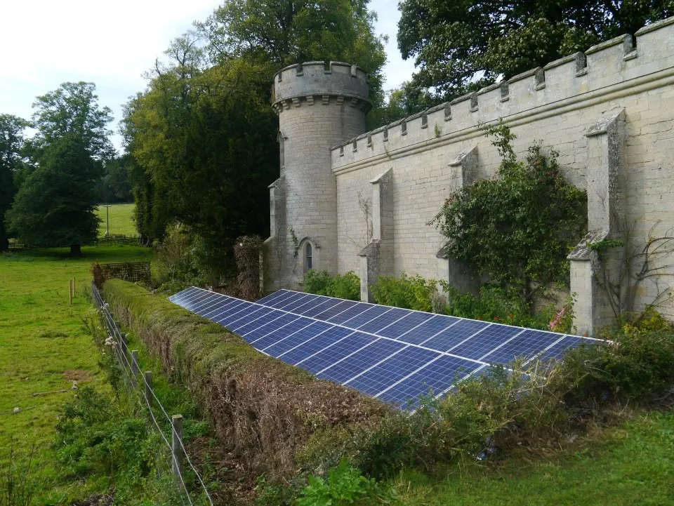 Ground-mounted solar array beside a historic stone wall in Yorkshire
